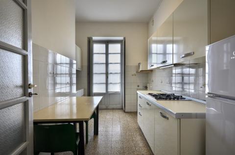 Cucina con tavolo, frigo e dispensa